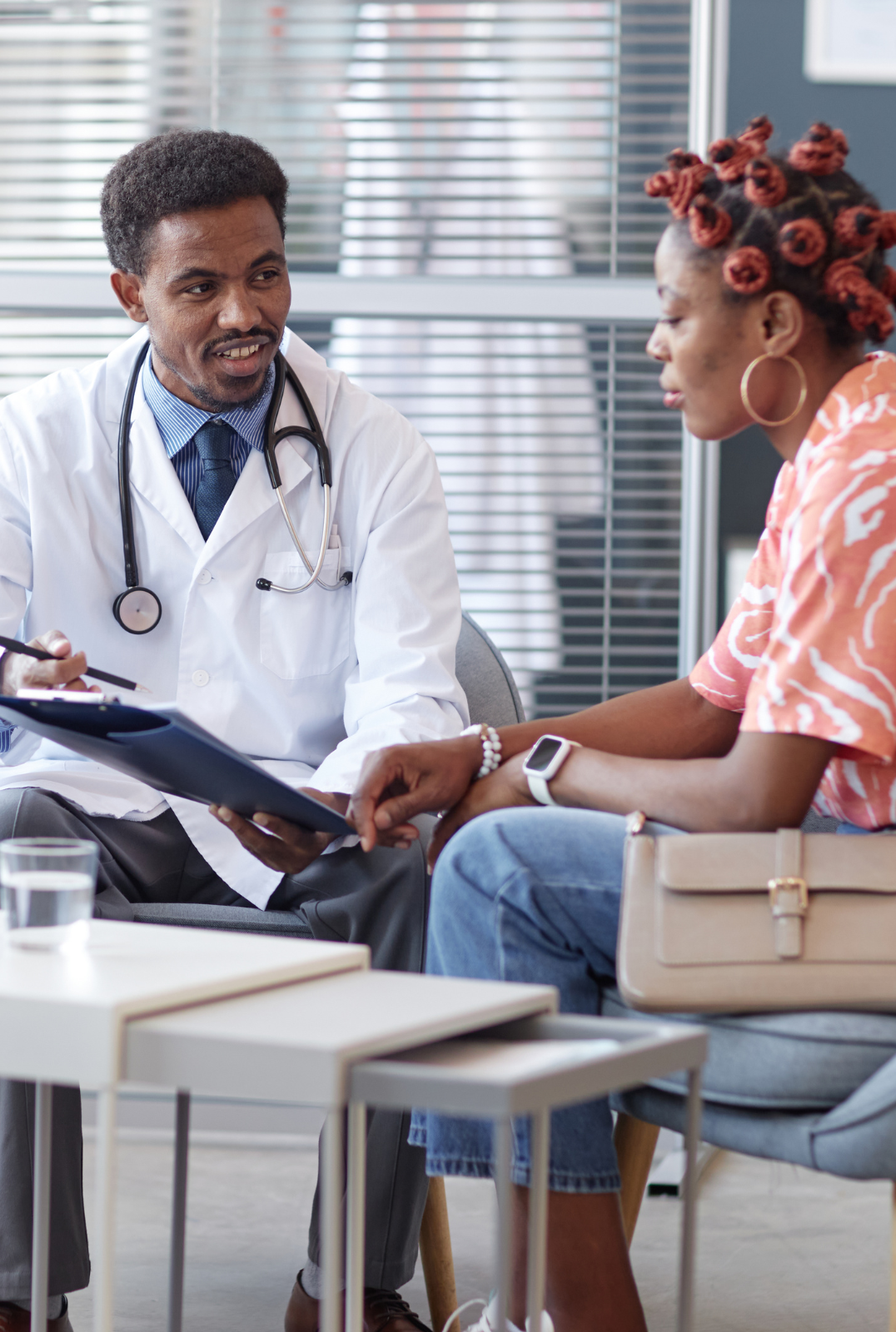 A doctor in Pretoria talking with a patient and her daughter during a consultation